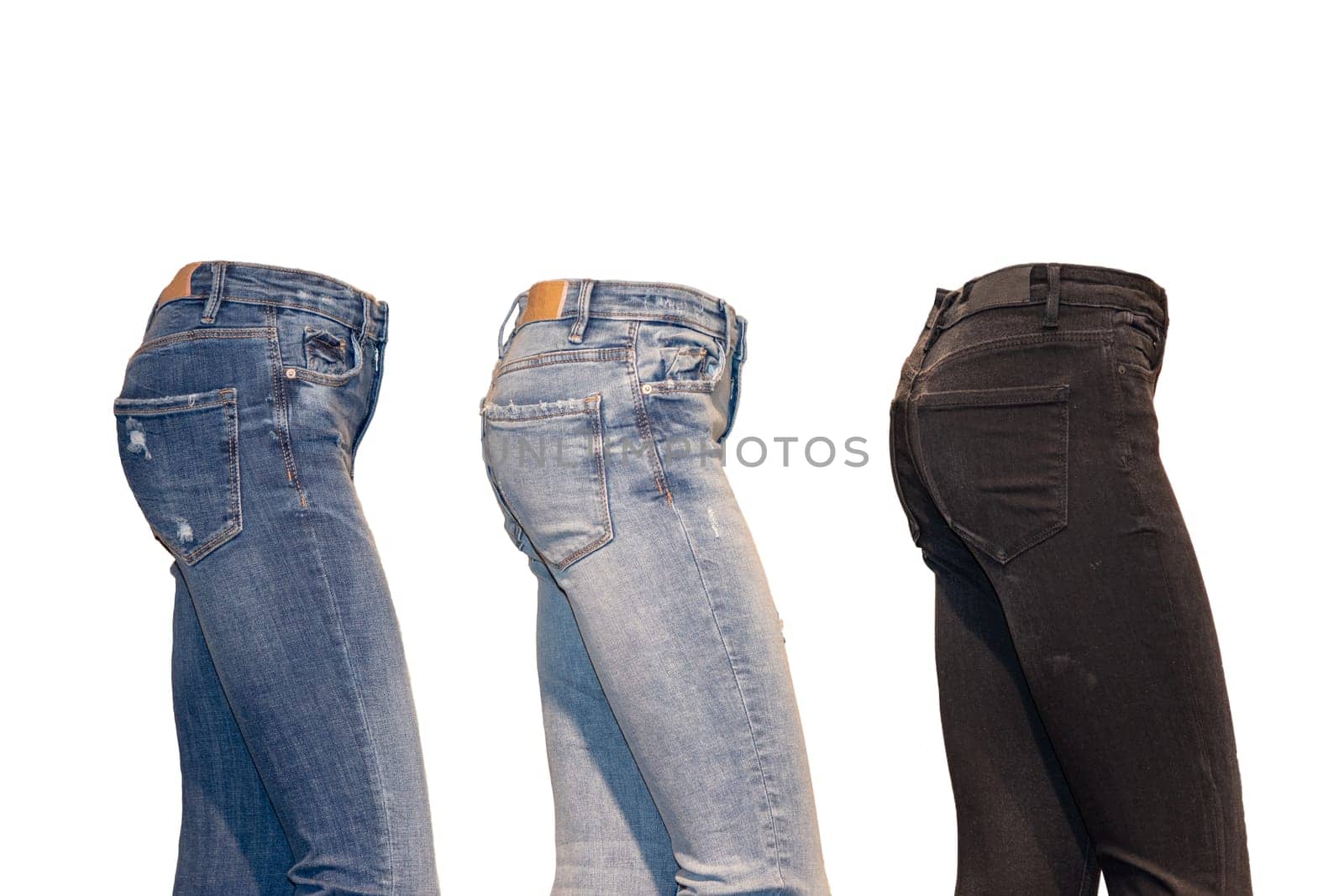 Set jeans isolated. Side view of a collection of three various denim pants on a ghost mannequin isolated on a white background. Advertising jeans shop. Jeans fashion.
