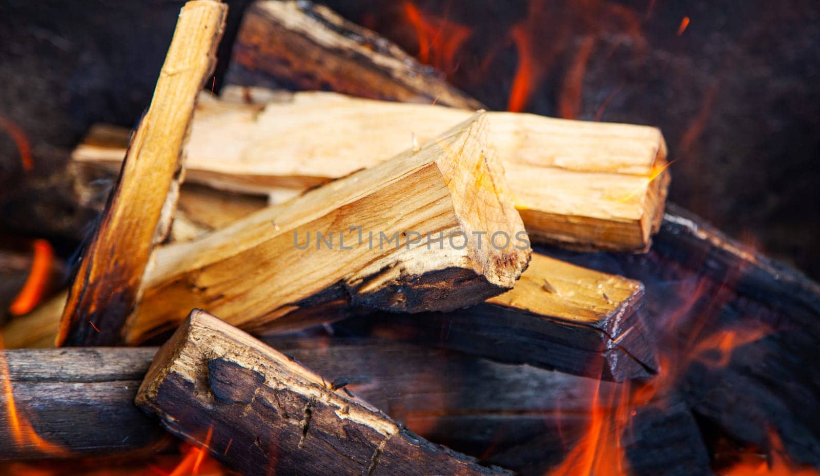 Burning wood. Fire in the grill closeup