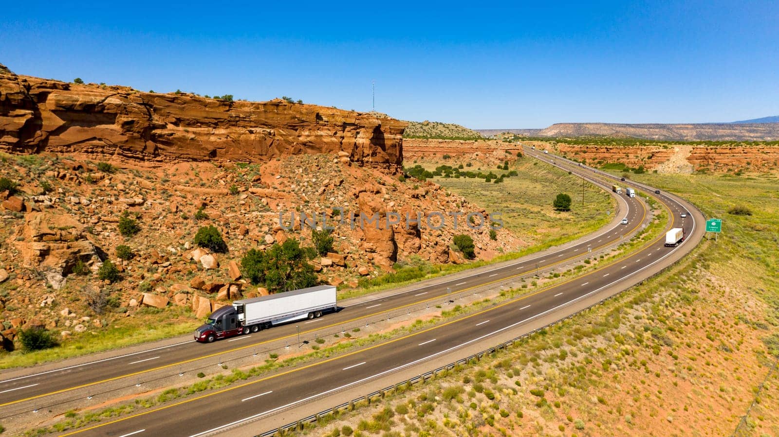Big Rigs and vacation tavelers drive along the highway in the desert southwest