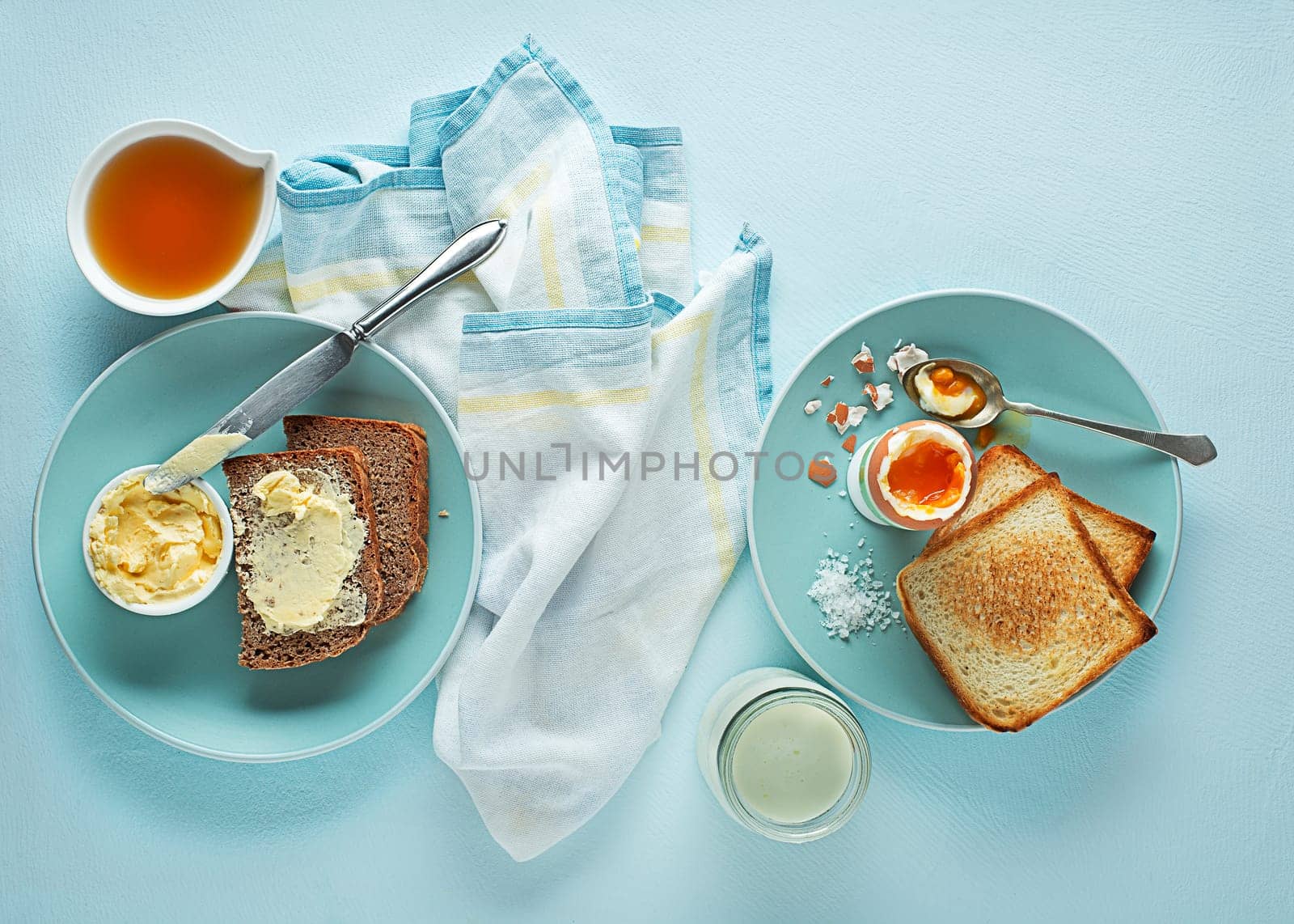 Breakfast served with boiled egg, honey and butter. Delicious good breakfast.