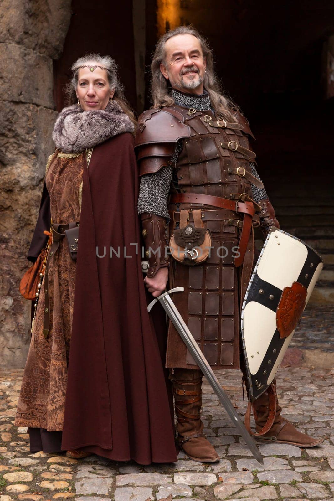 Couple posing robed in beautiful medieval clothing