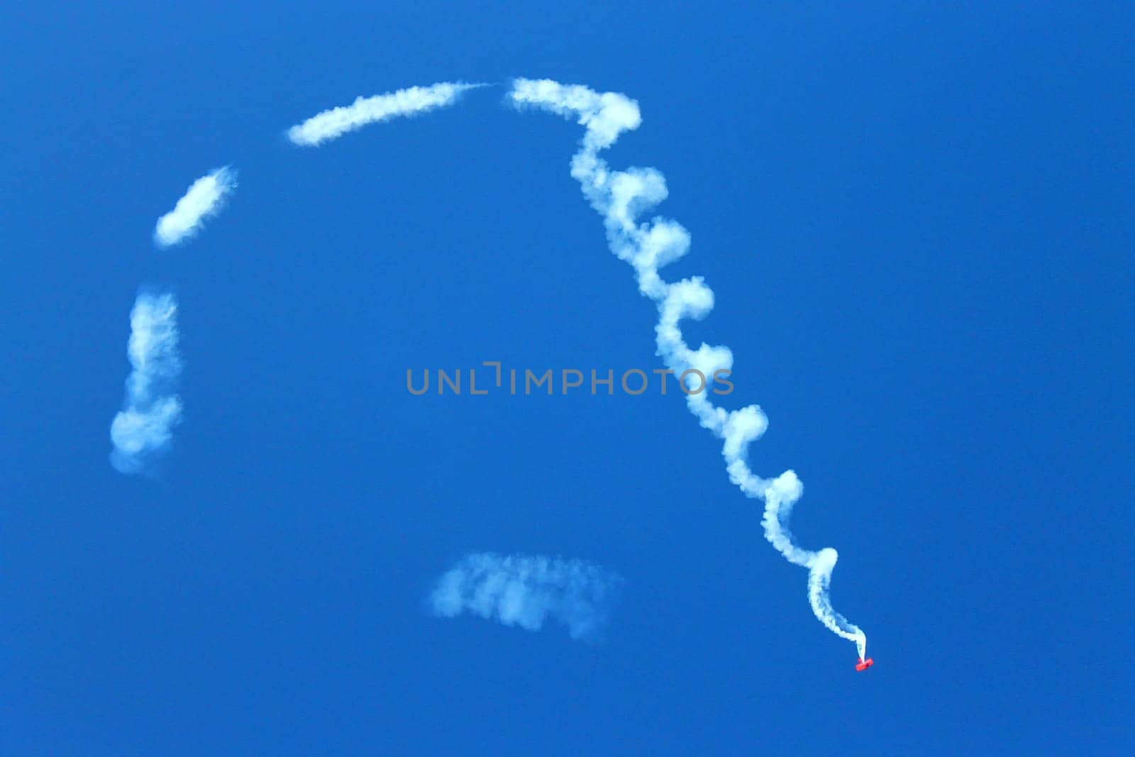 The falling airplane in the blue sky