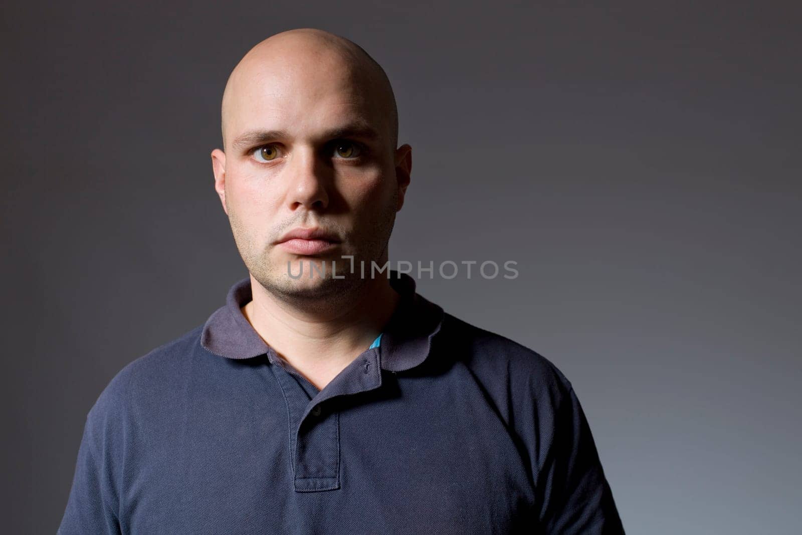 Portrait of young man thinking on a black background