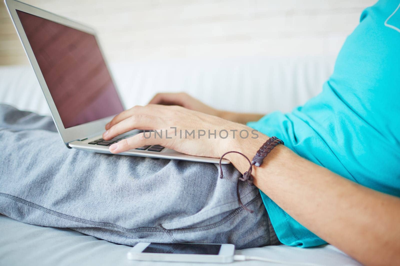 Young man typing while having rest