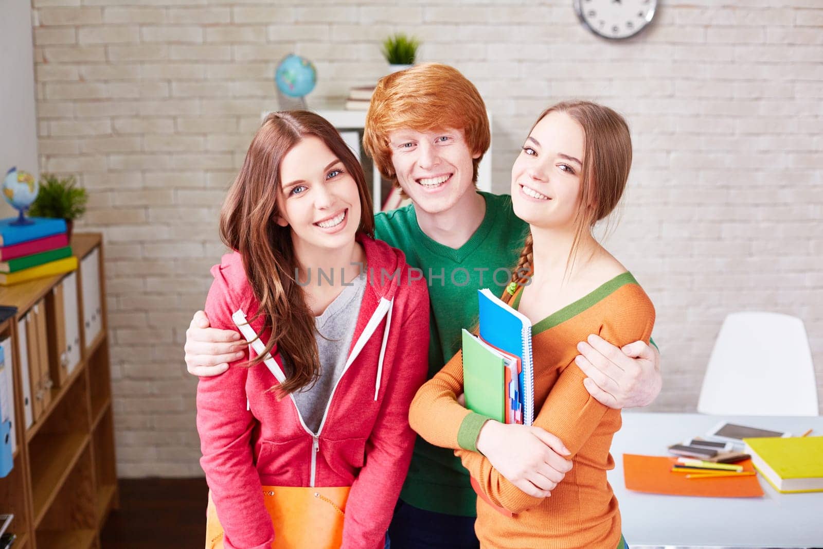 Affectionate students in casualwear looking at camera