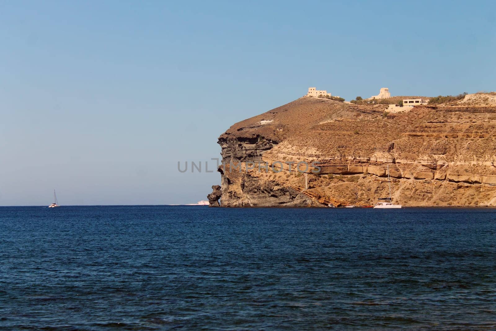 The cliff and the boats in Greece