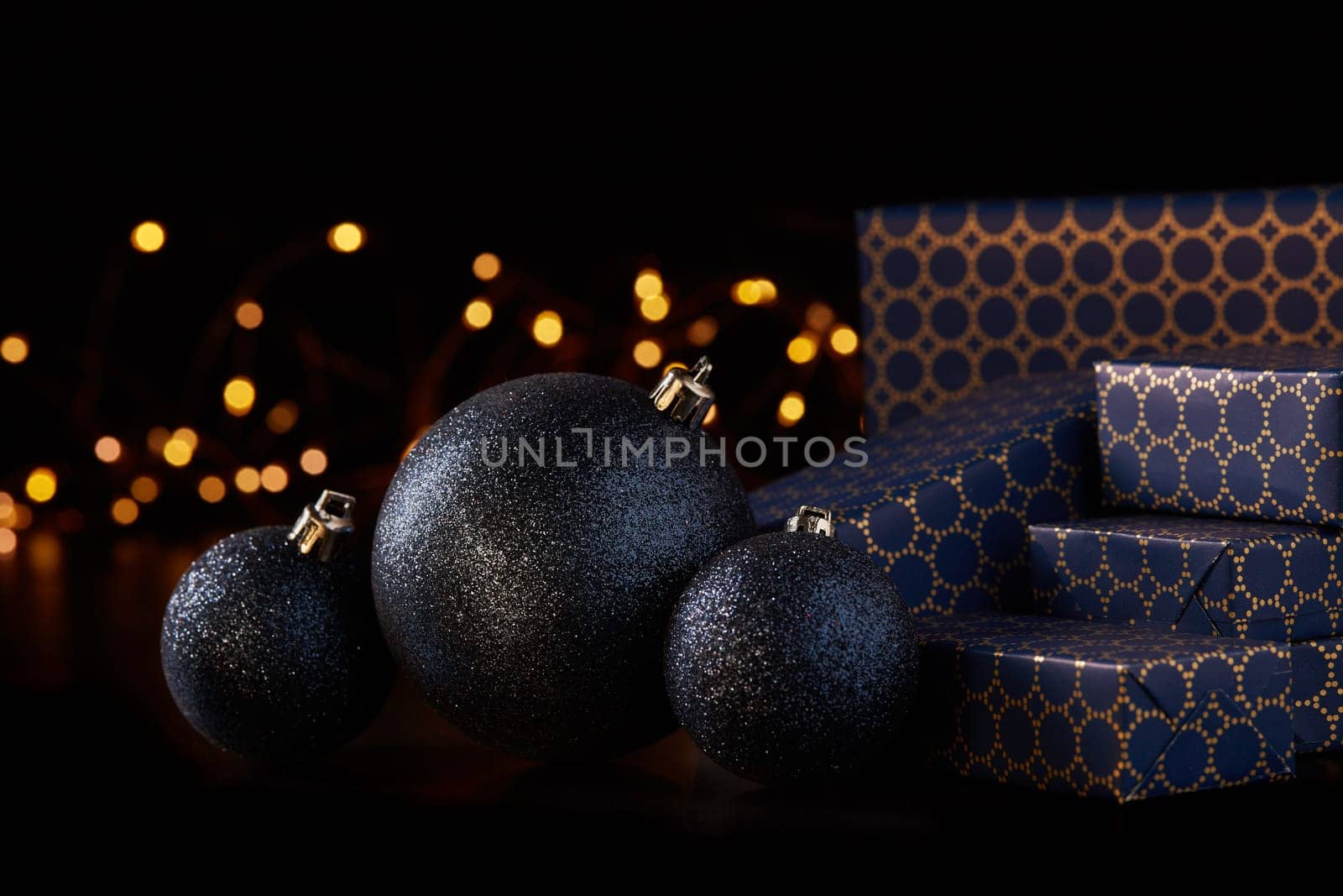 Gift boxes, Christmas decoration with LED lights garland on a black background. Christmas and New Year shopping. Greeting card