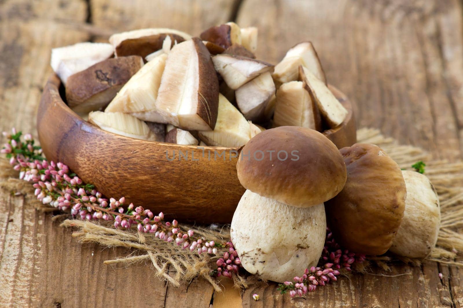 fresh mushrooms (boletus) in a bowl - wooden background