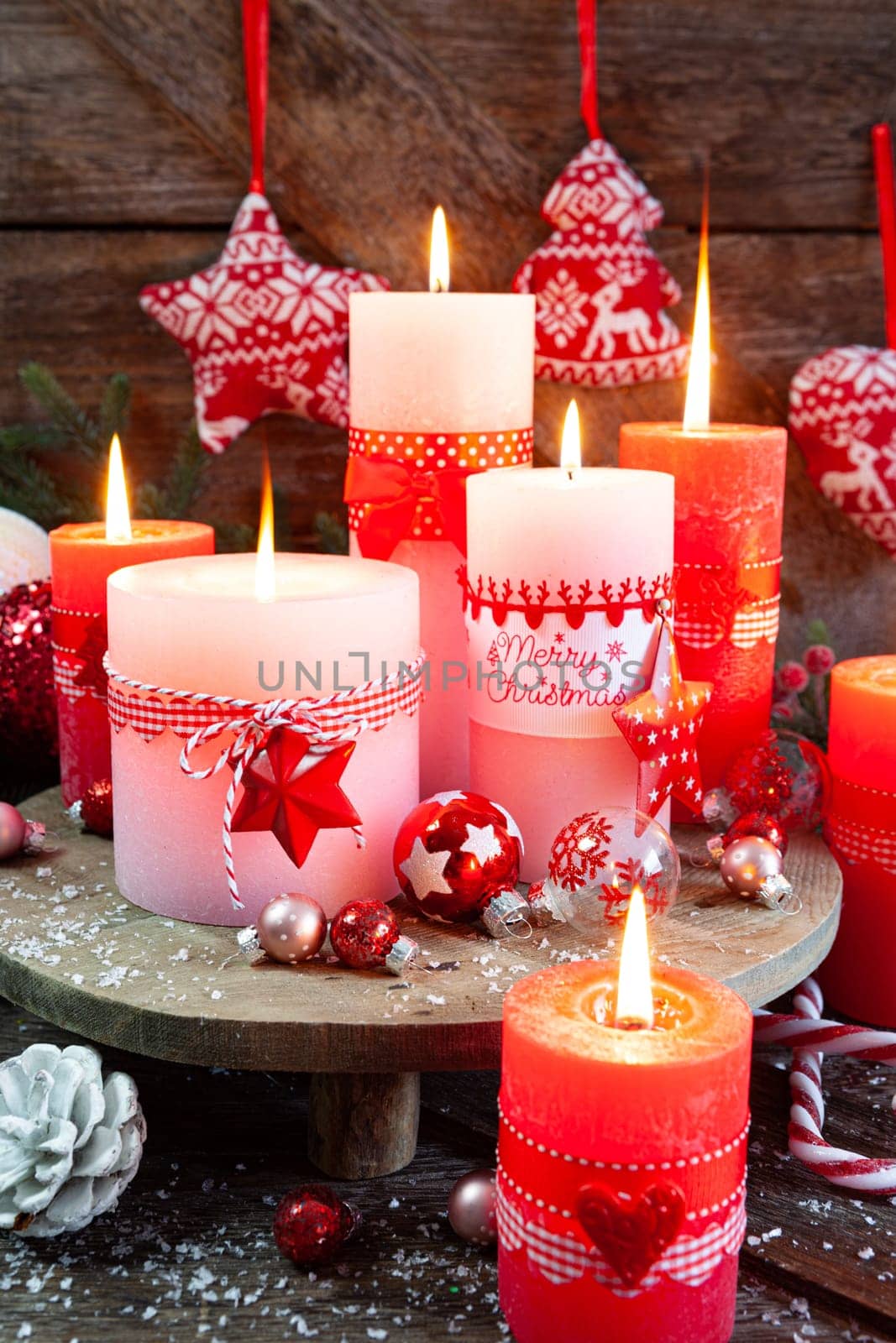 Colorful burning candles and festive decorations for Christmas