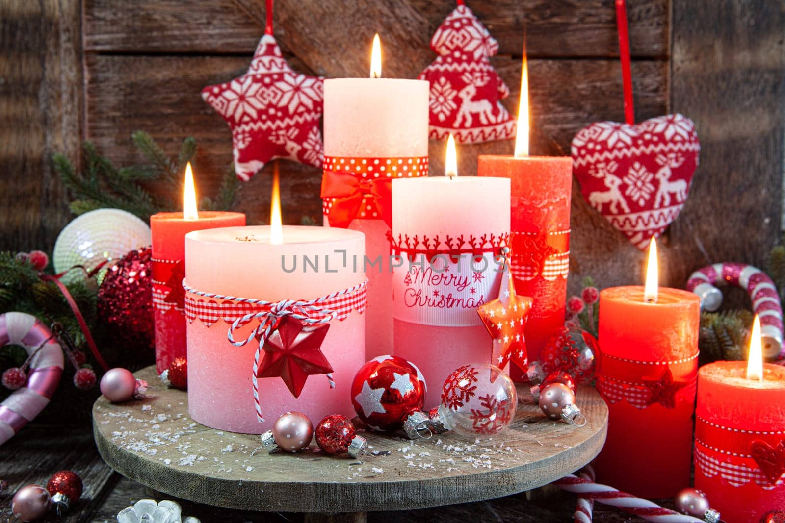 Colorful burning candles and festive decorations for Christmas