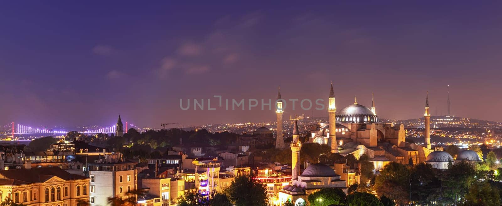 Hagia Sophia and the Bosphorus Bridge, evening panorama of Istanbul.