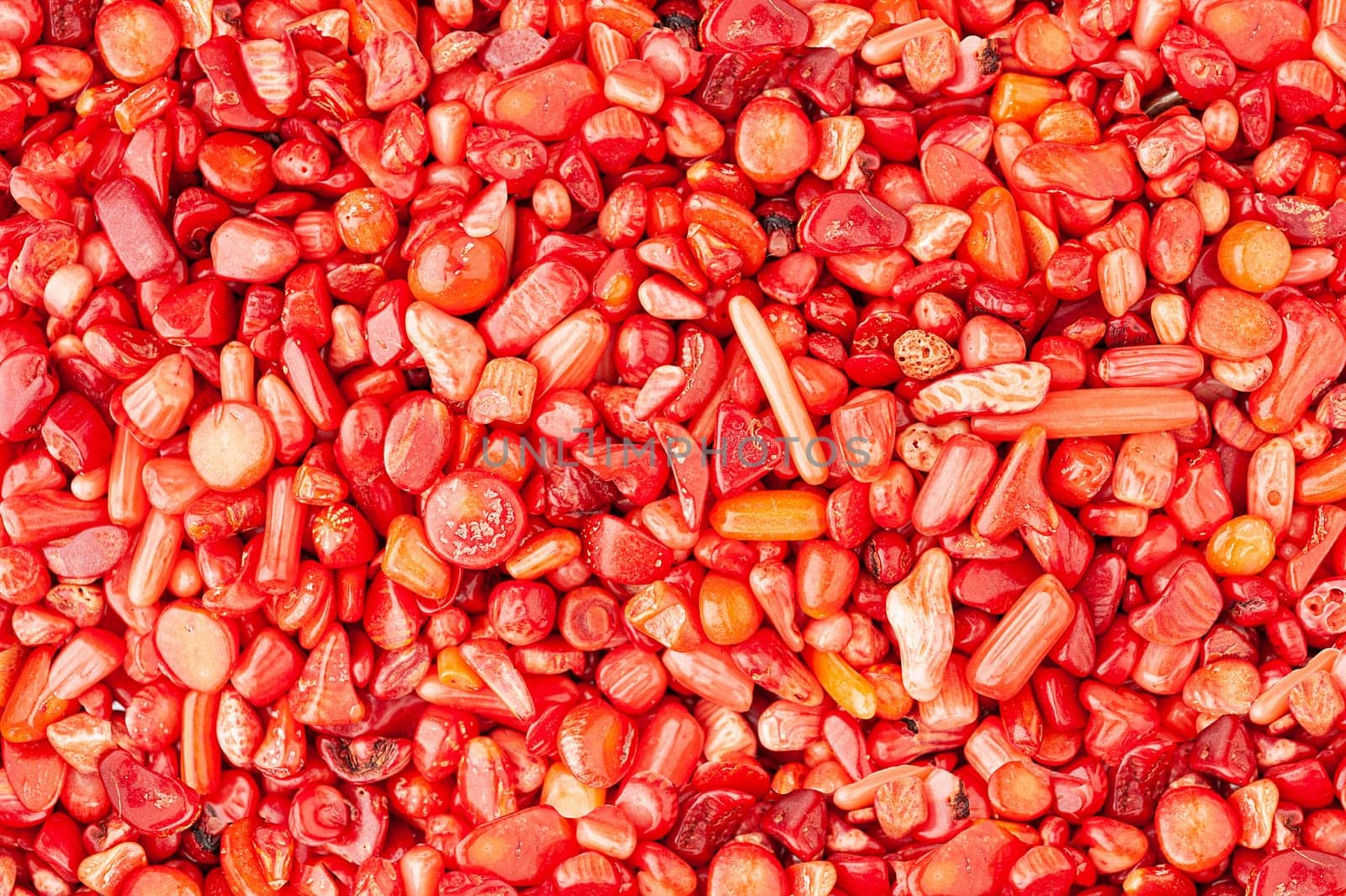 Small stones rounded red coral texture background