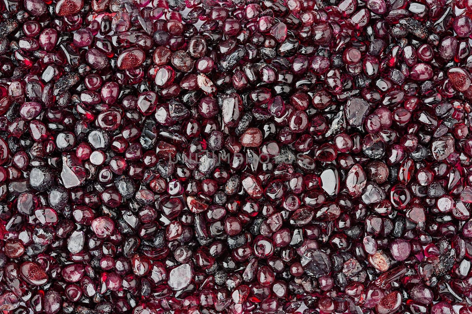 Small rounded garnet stones textured background