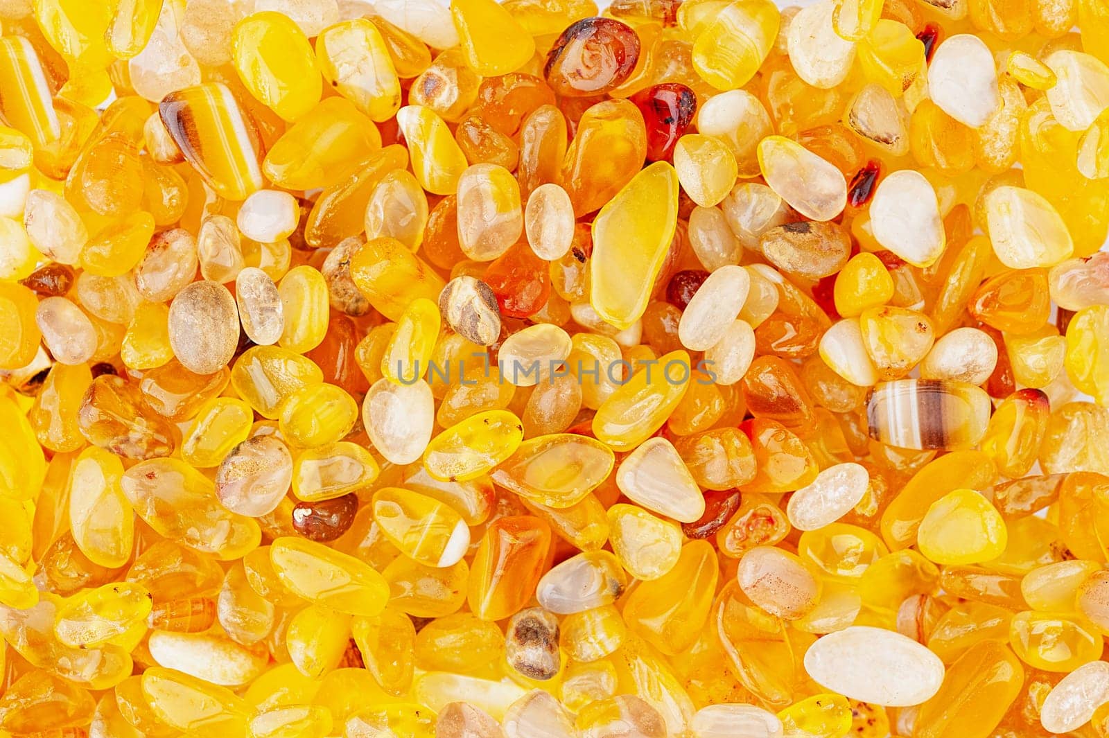 Small rounded yellow agate stones textured background