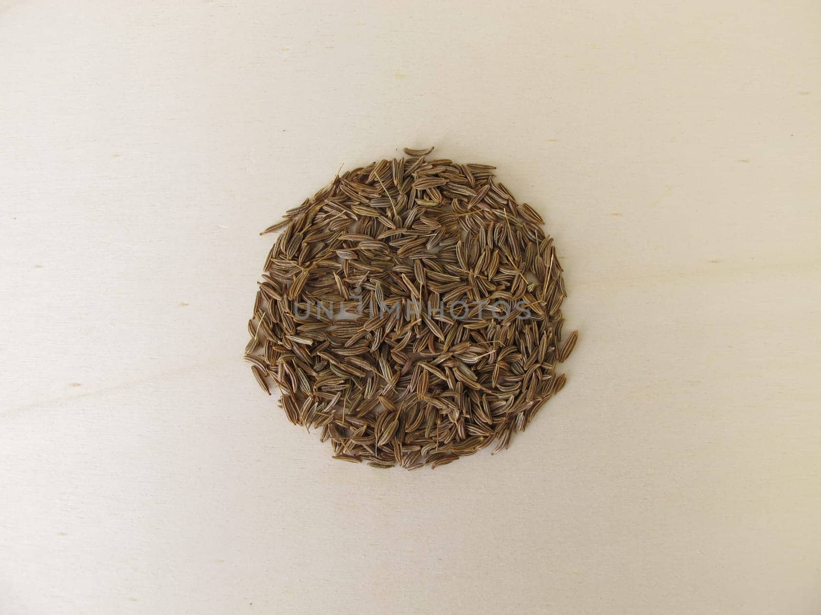 Caraway seeds, Carum carvi, on a wooden board