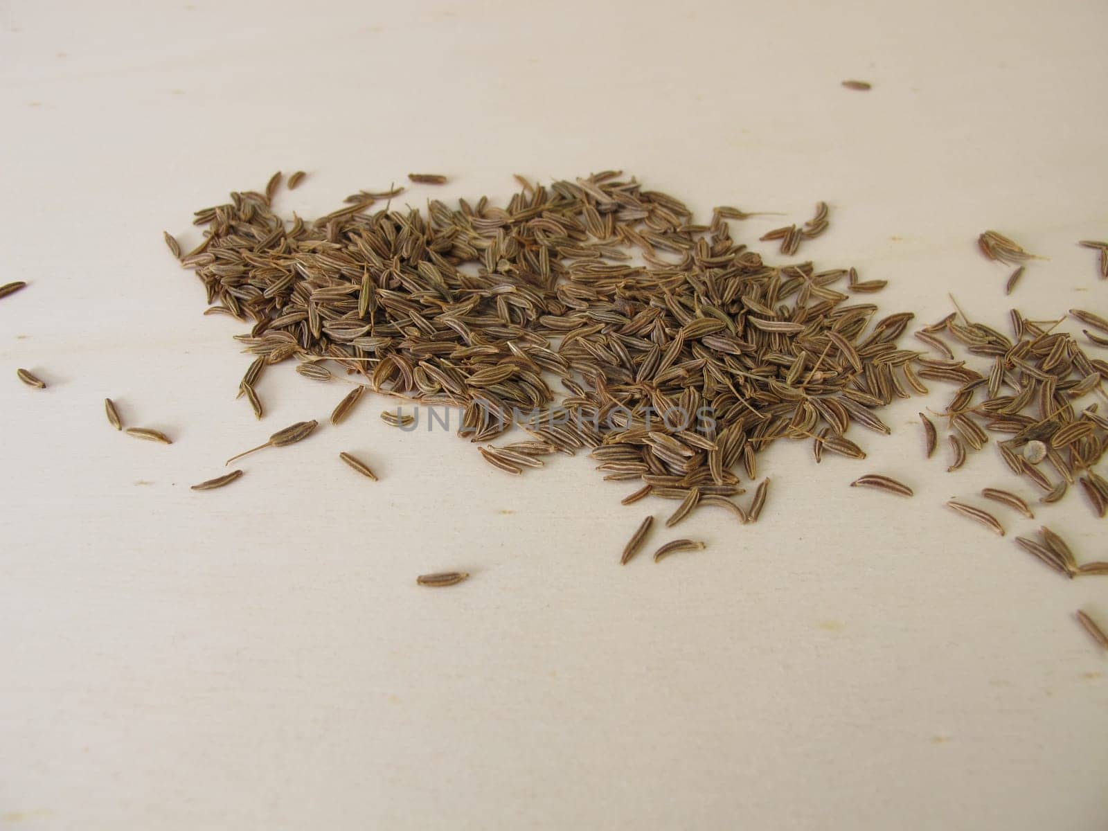 Caraway seeds, Carum carvi, on a wooden board