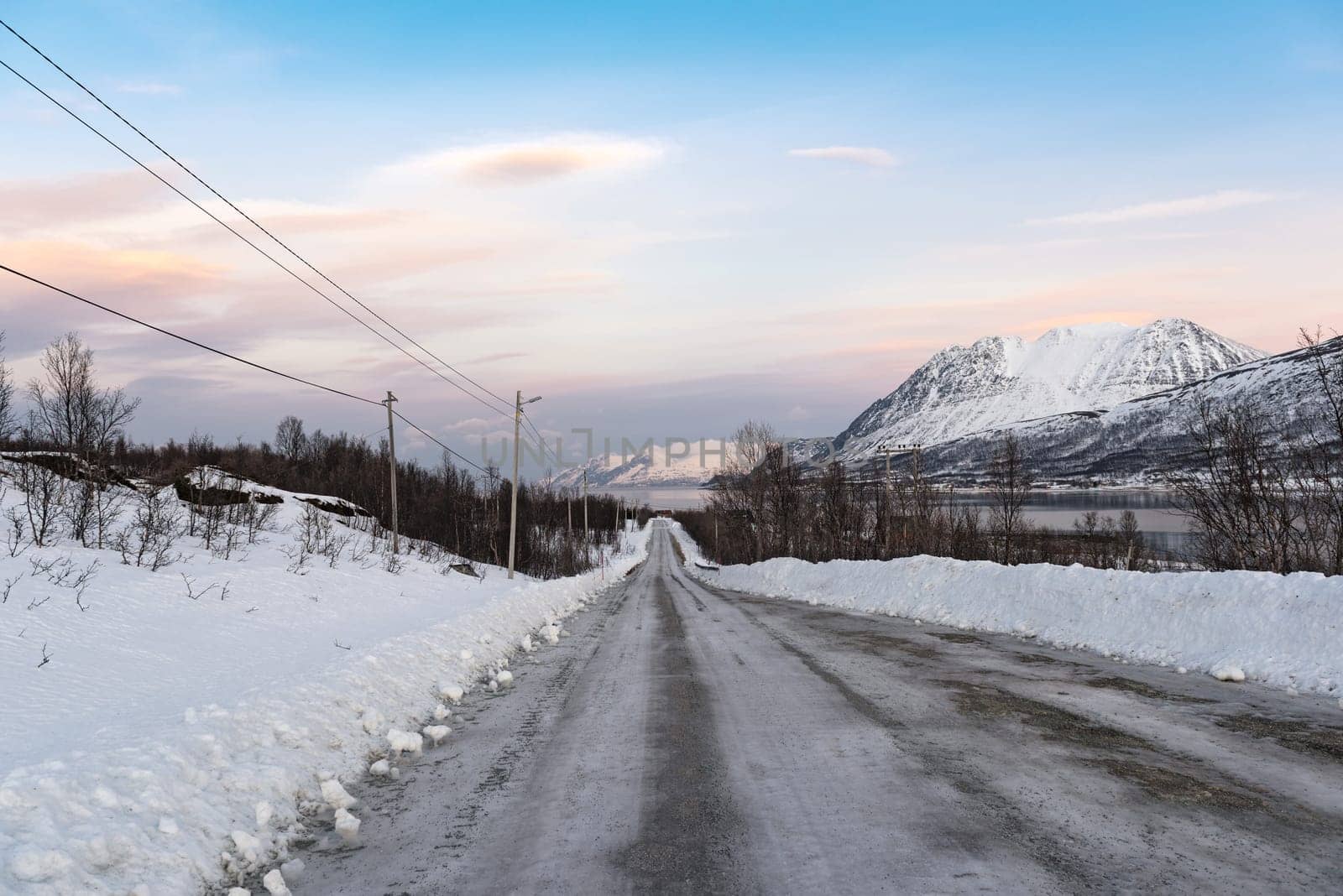 icy road on the bank of Ullsfjord in County Troms Norway