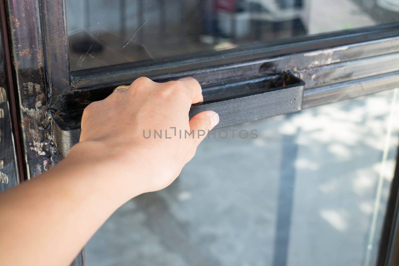 Hand on black door holder, stock photo