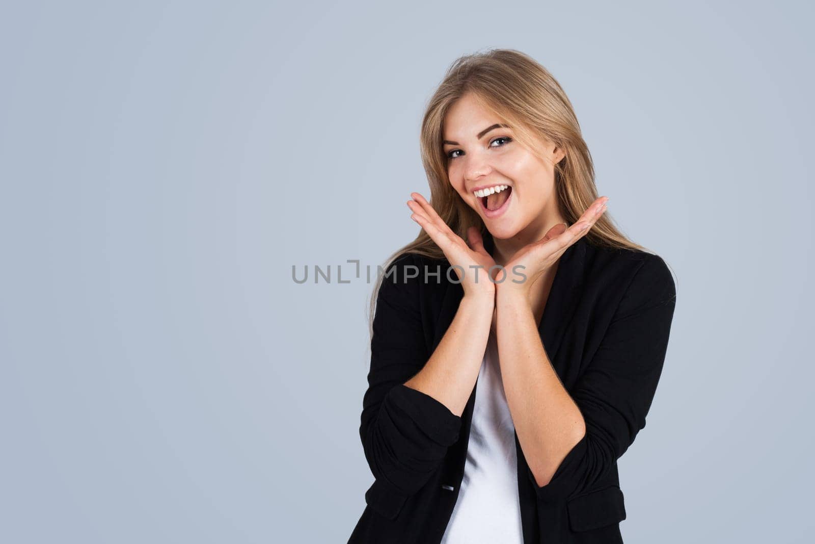 Young woman very happy, copyspace, isolated on grey