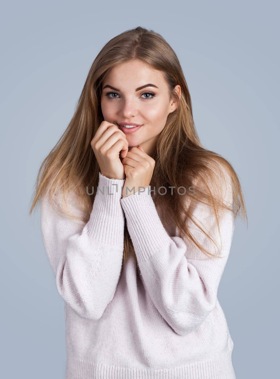 Portrait of a sensual young woman, isolated on grey background
