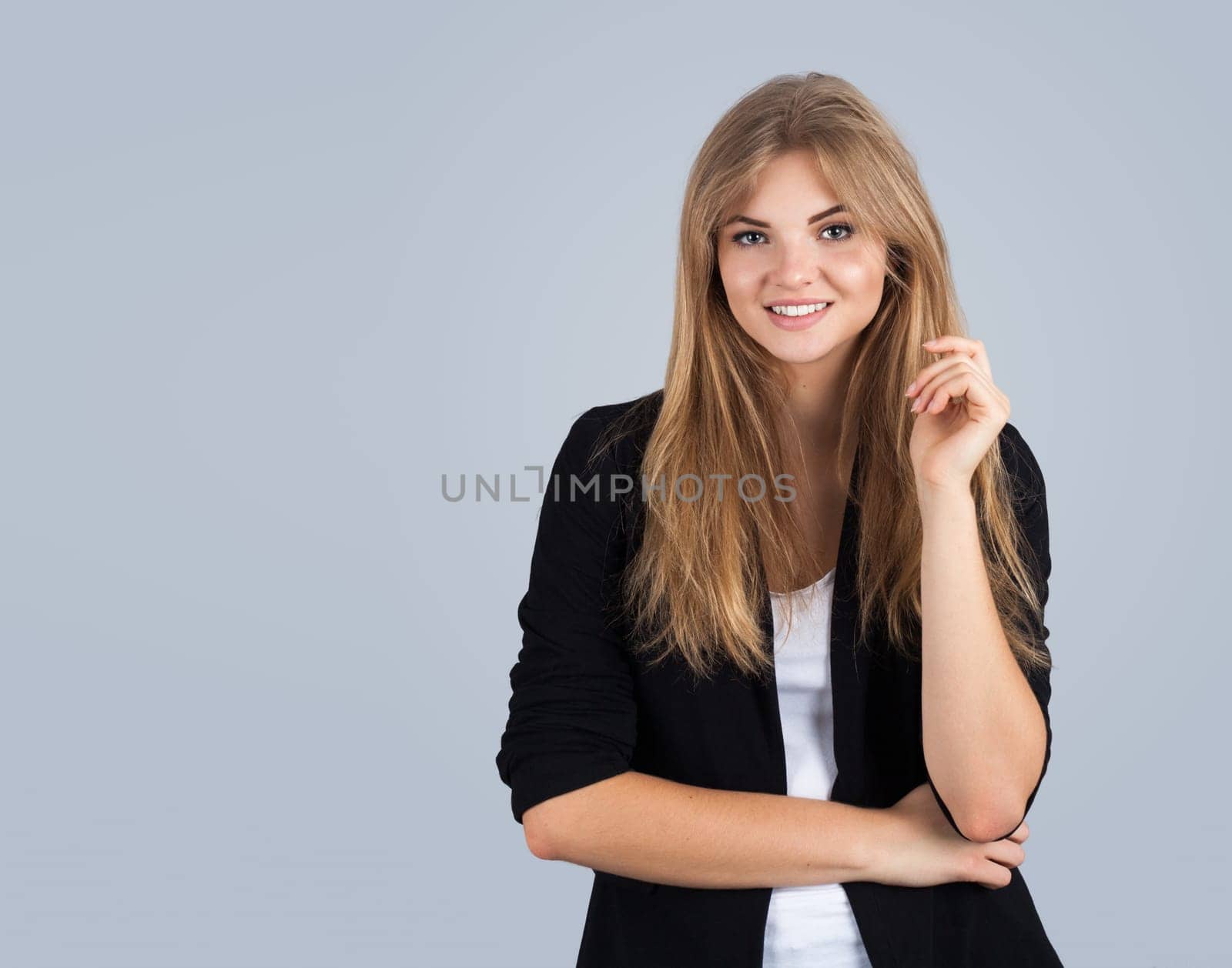 Beautiful young woman isolated on grey