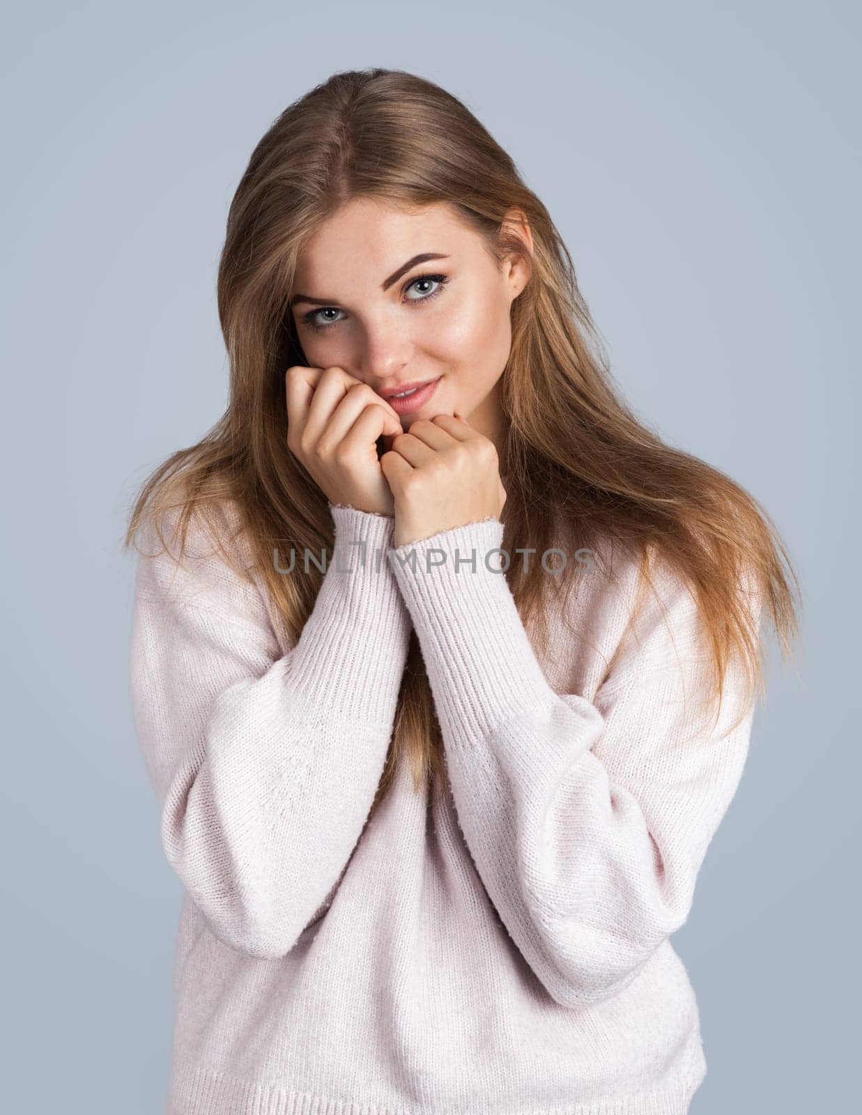 Portrait of a sensual blonde woman, isolated on grey background