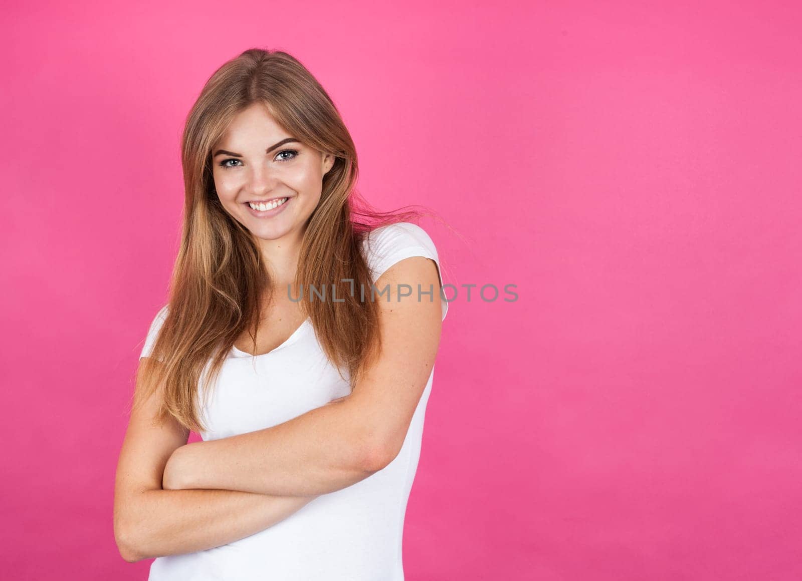 Smiling blonde girl, copyspace, isolated on pink background