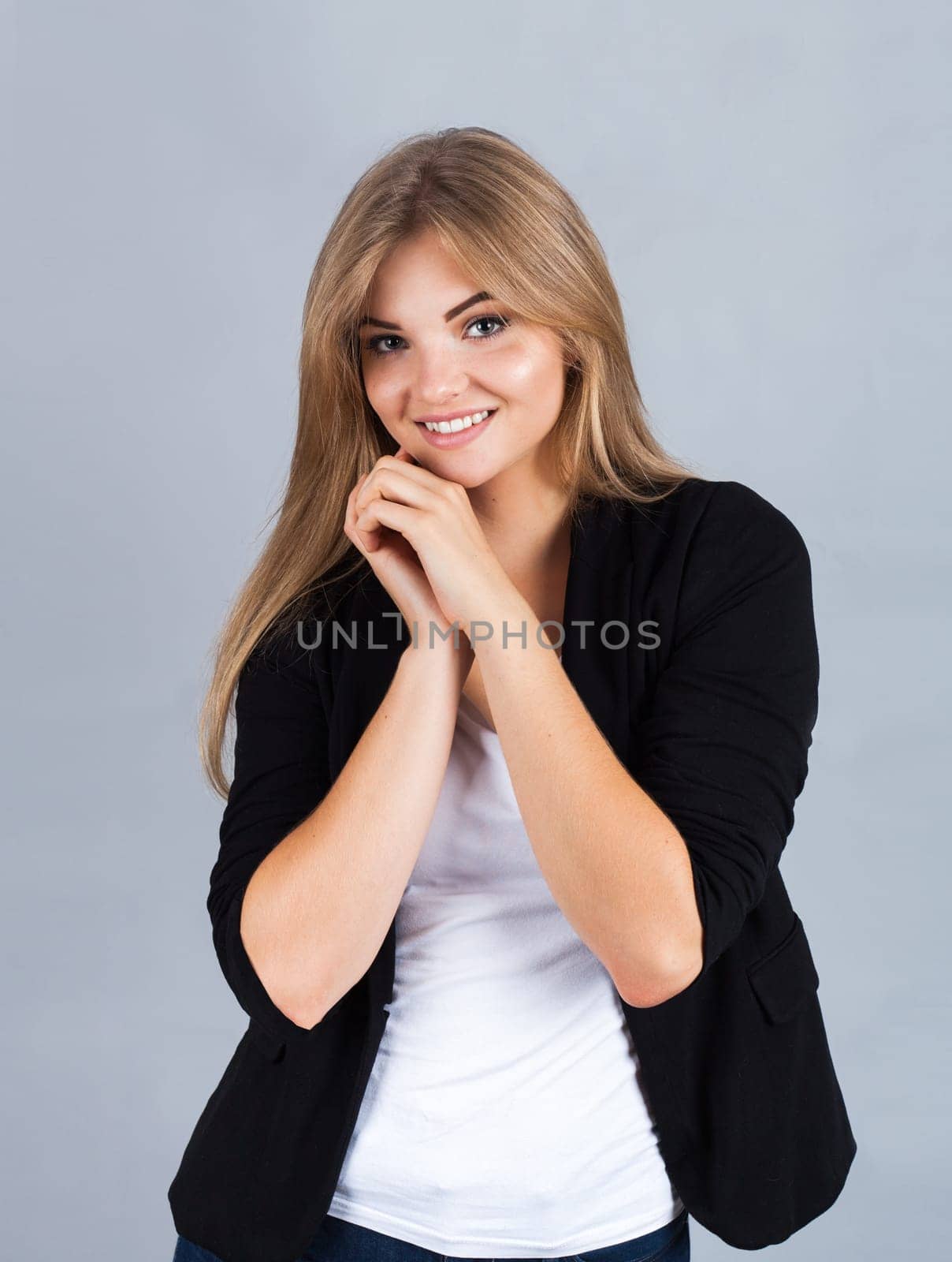 Portrait of a charming young woman, isolated on grey