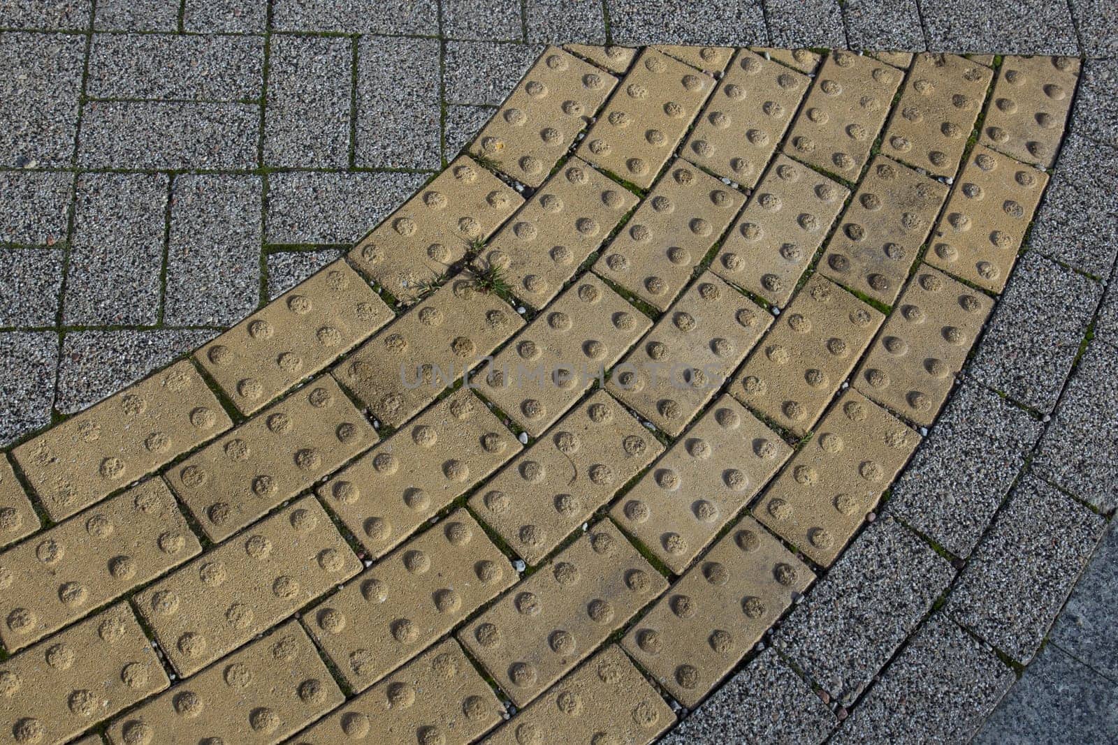 Block tactile paving for blind handicap. Tactile paving for blind handicap on tiles pathway before street crossing