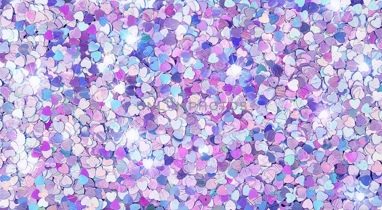 Real shiny heart-shaped sparkles textured background