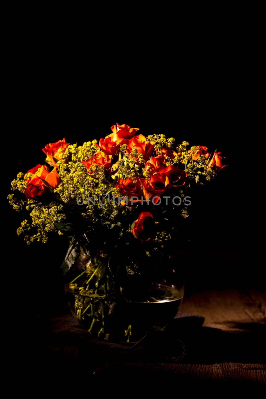 orange bouquet of roses in glass vase