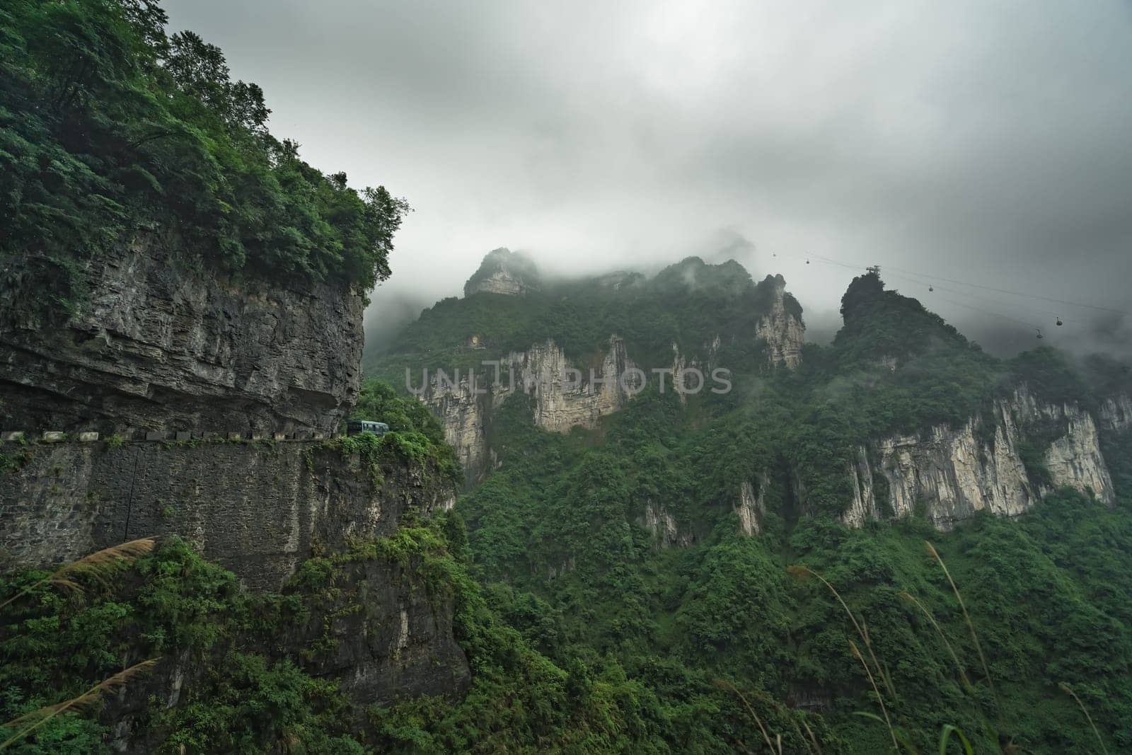 Bus with tourists driving up the winding road of 99 turns to the top of the Tianmen Mountain, Zhangjiajie National Park, Hunan, China