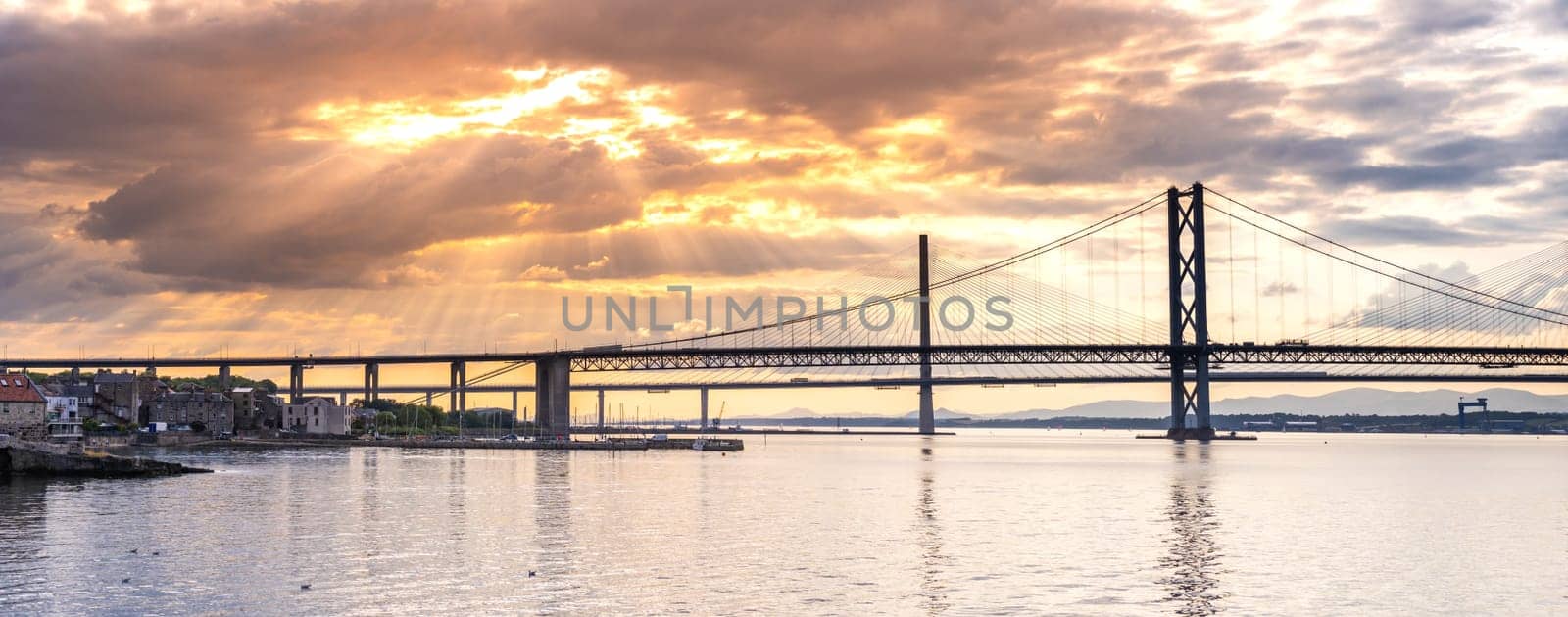 Panorama of beautiful sunset at The Forth road bridge and Queensferry crossing bridge in Edinburgh Scotland UK.