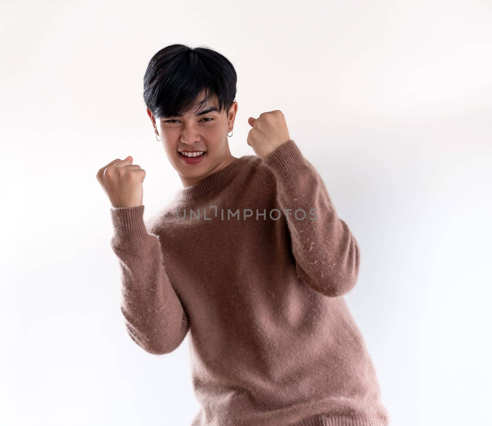 Portrait of good-looking smart Teenager young asian adult boy wearing brown sweater for winter on white background