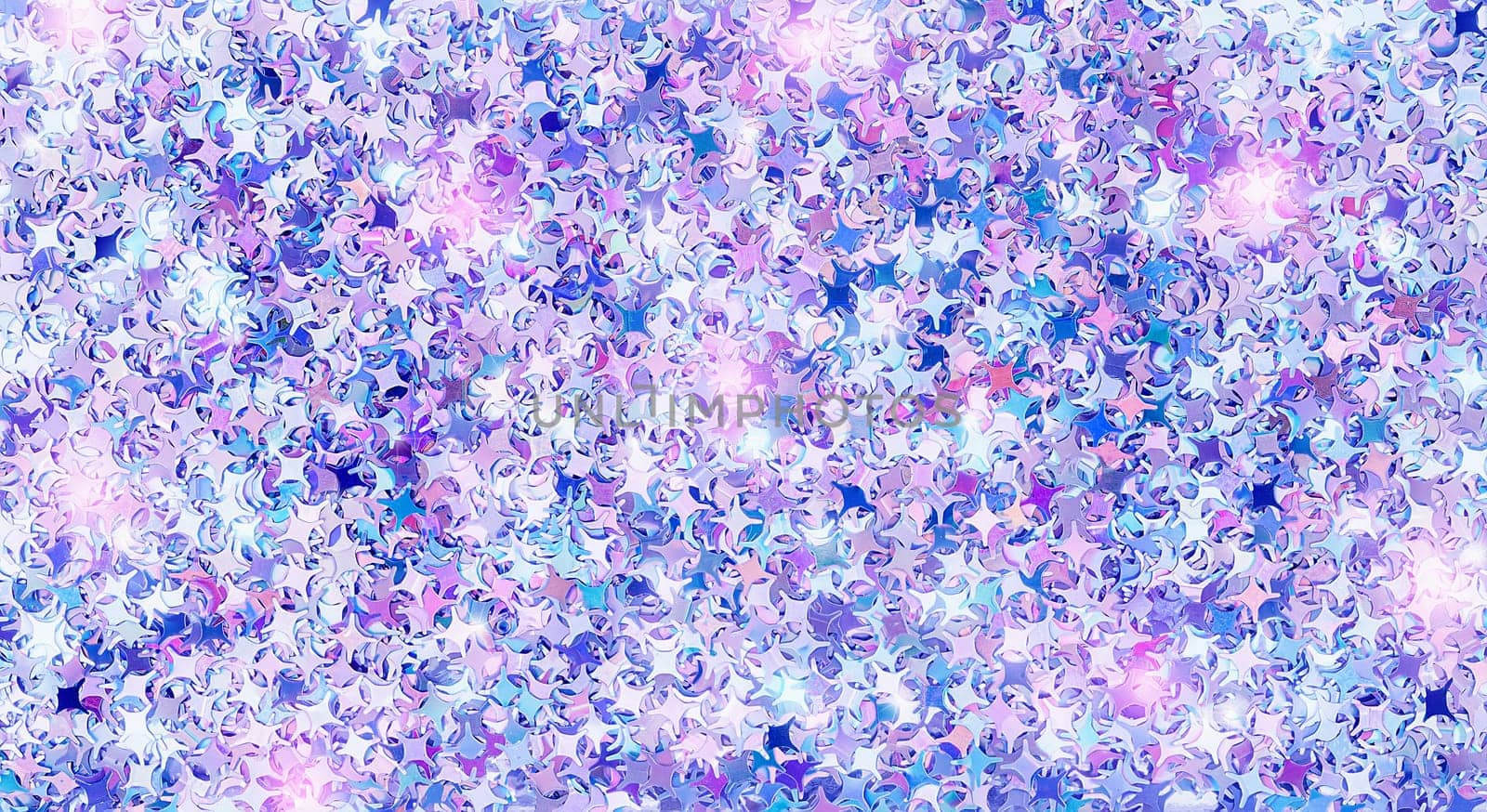 Real shiny four pointed star shape sparkles textured background