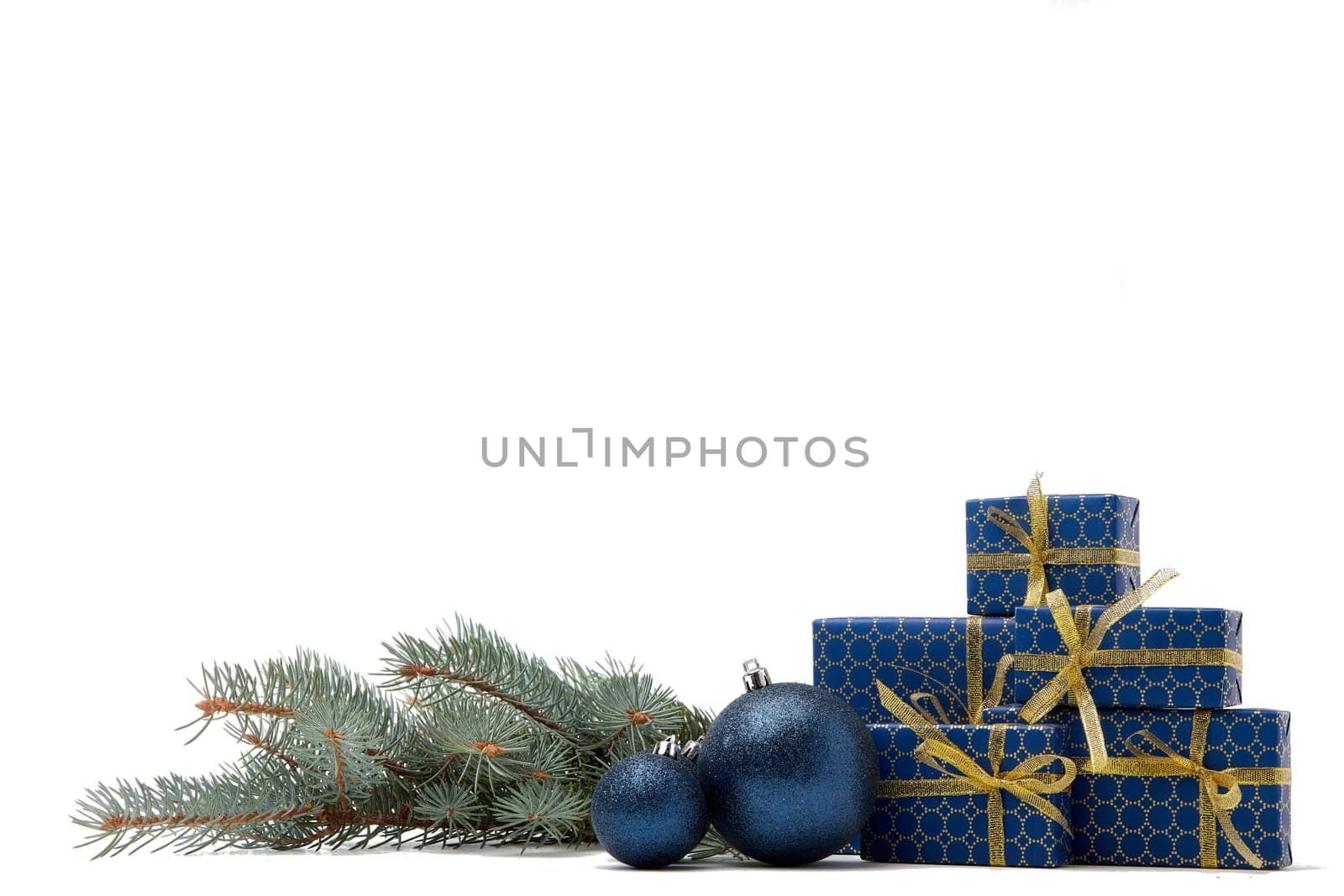 Gift boxes and Christmas decoration with fir tree branch isolated on white background with copy space. Christmas and New Year shopping. Greeting card