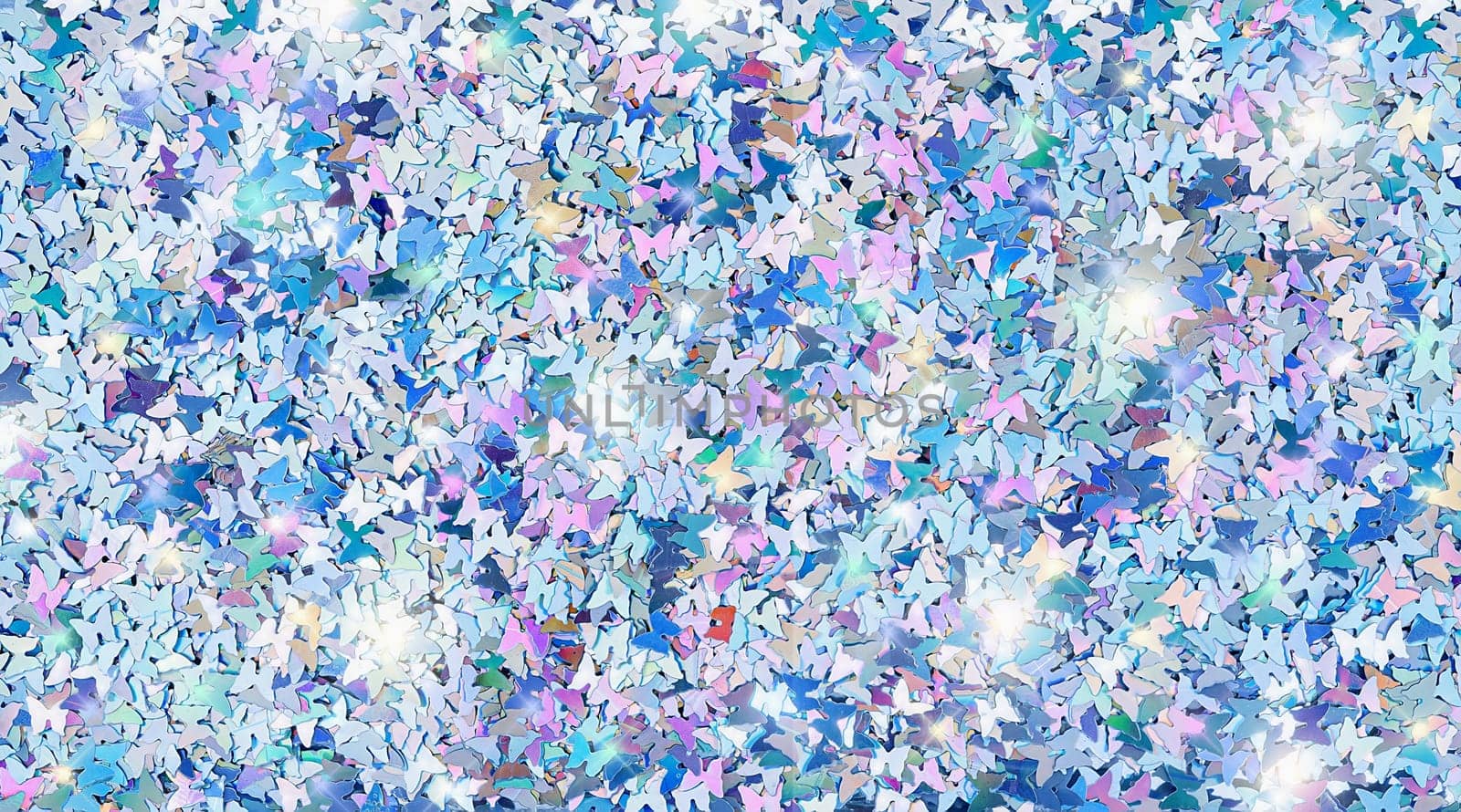 Real shiny butterfly shaped sparkles textured background