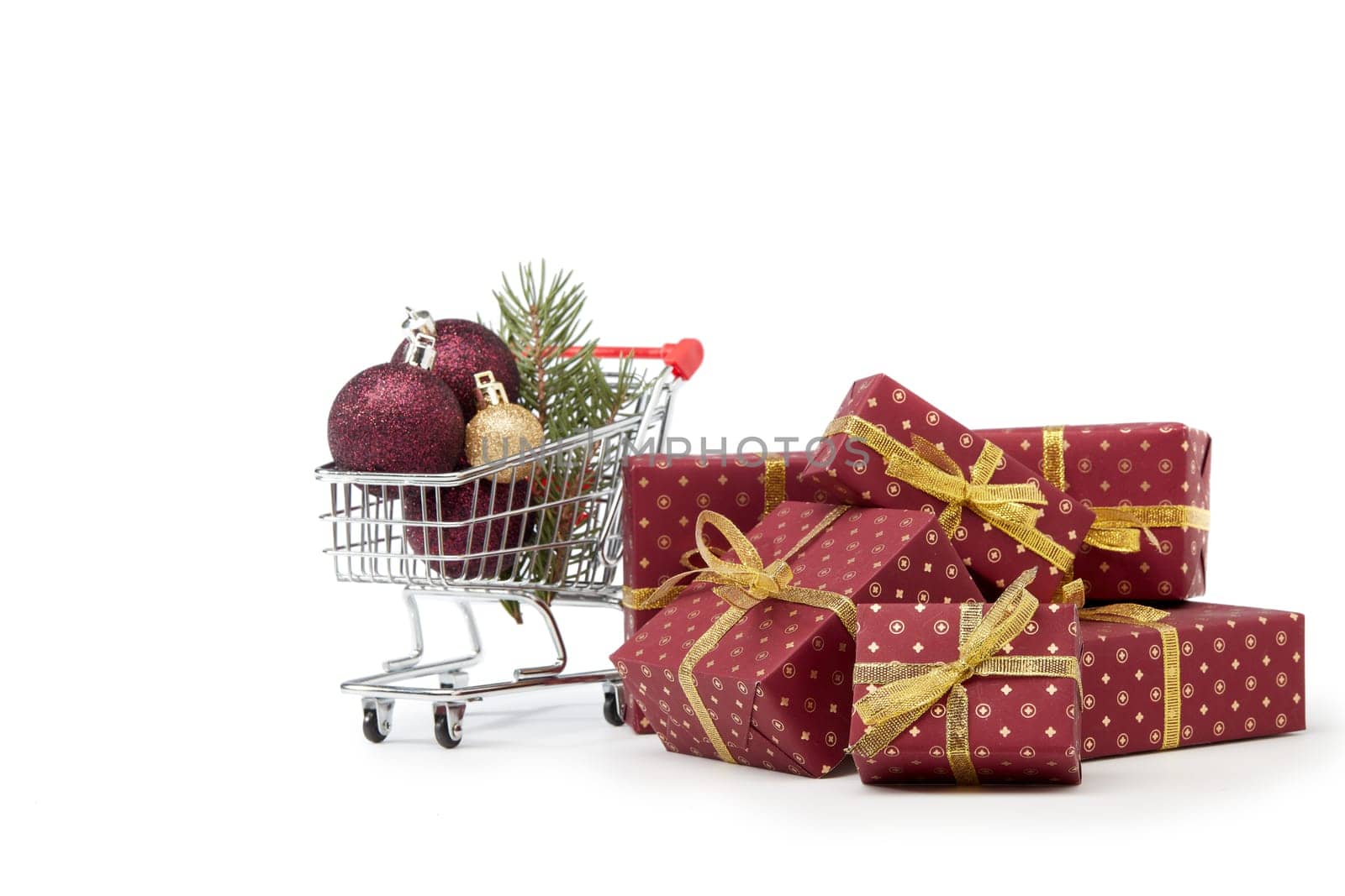 Shopping trolley, gift boxes and Christmas decoration isolated on white background, Christmas and New Year shopping. Winter sale.