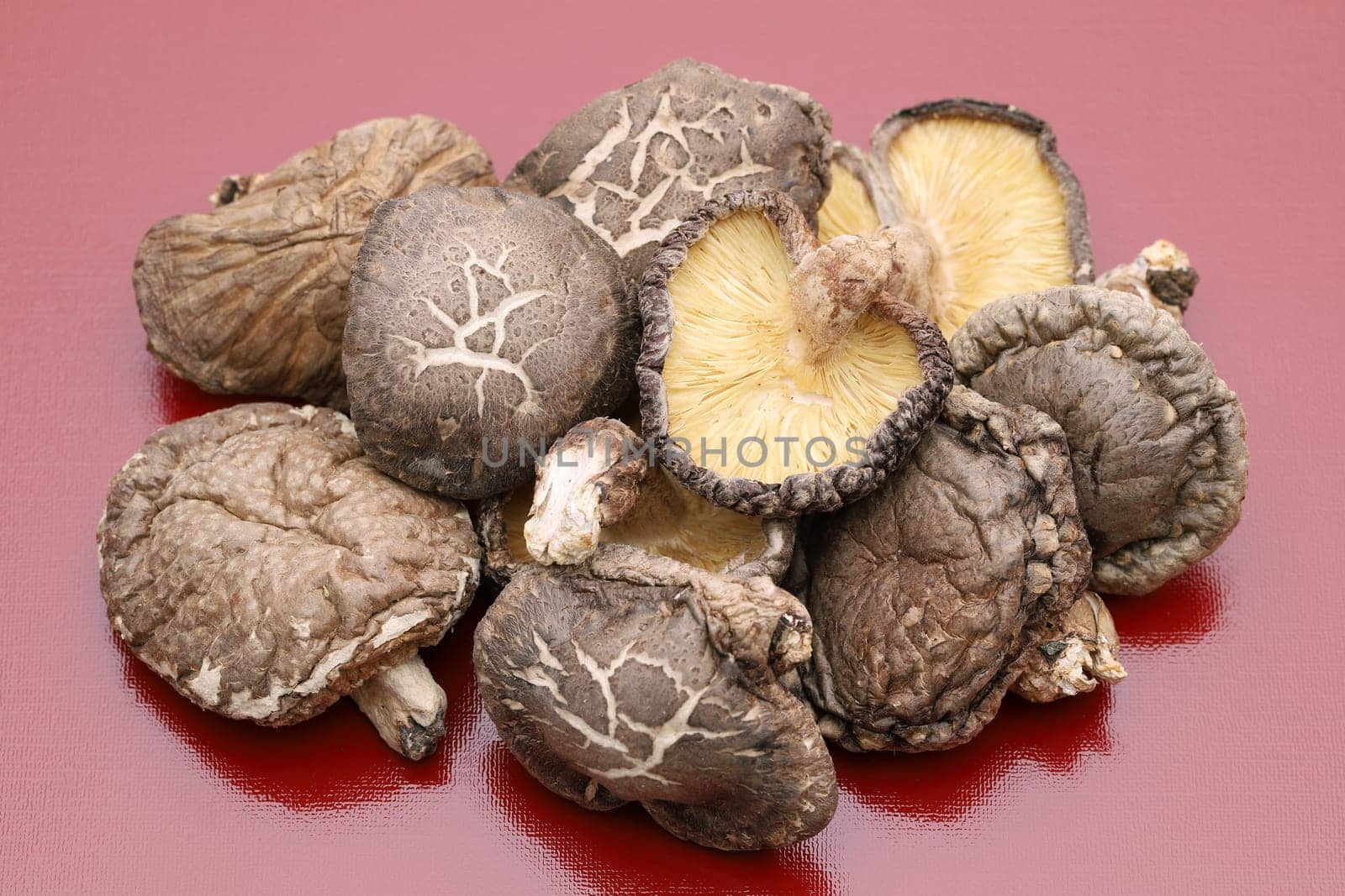 Japanese dried shiitake mushrooms on red background