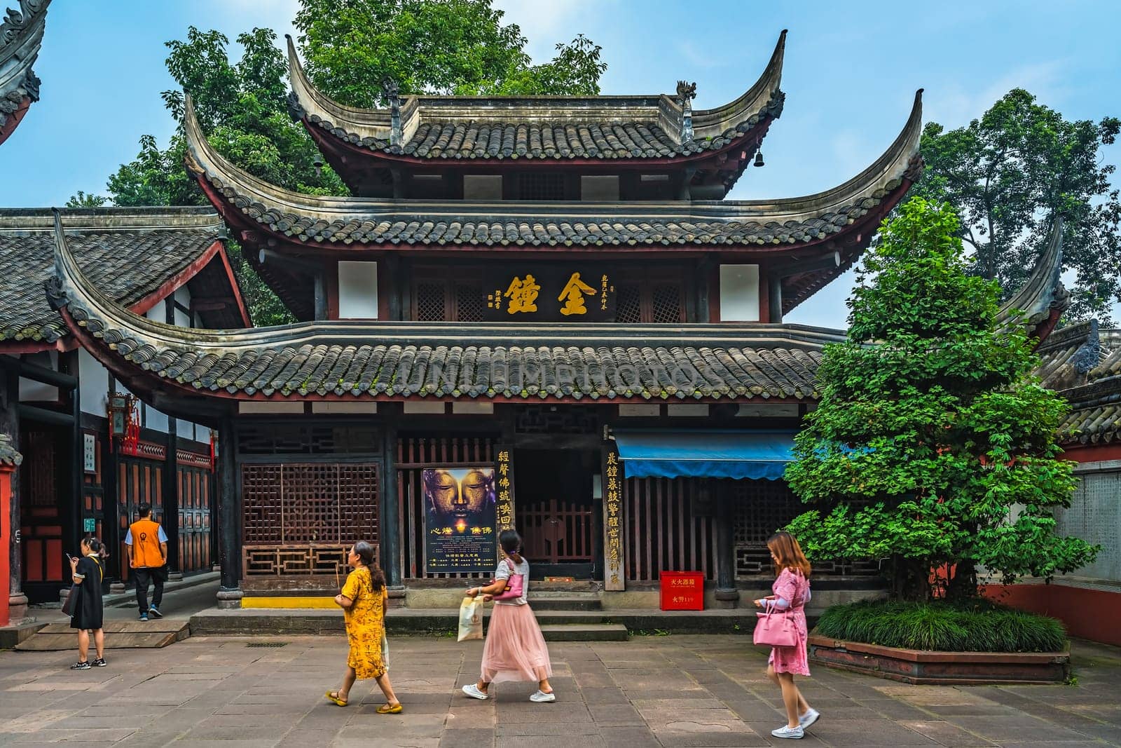 Chengdu, China -  July 2019 :  Female tourists walking in the courtyard of the Buddhist Wenshu Monastery, Sichuan Province