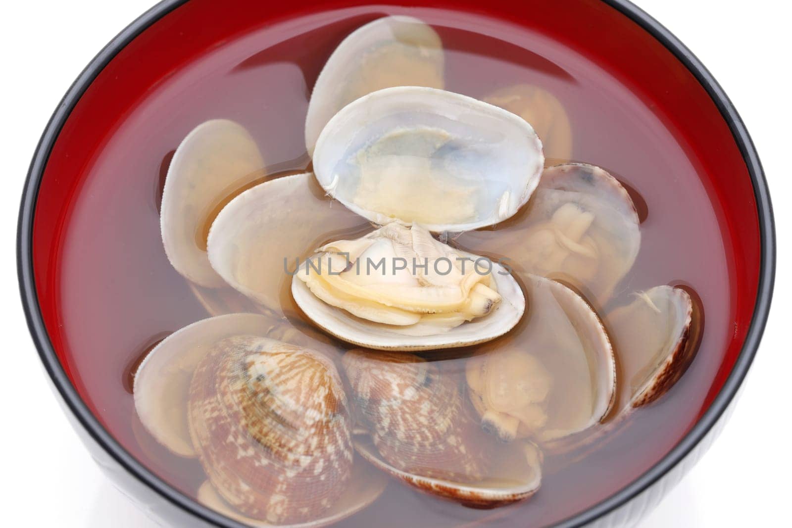 Japanese soy sauce soup with asari clams in a bowl on white background
