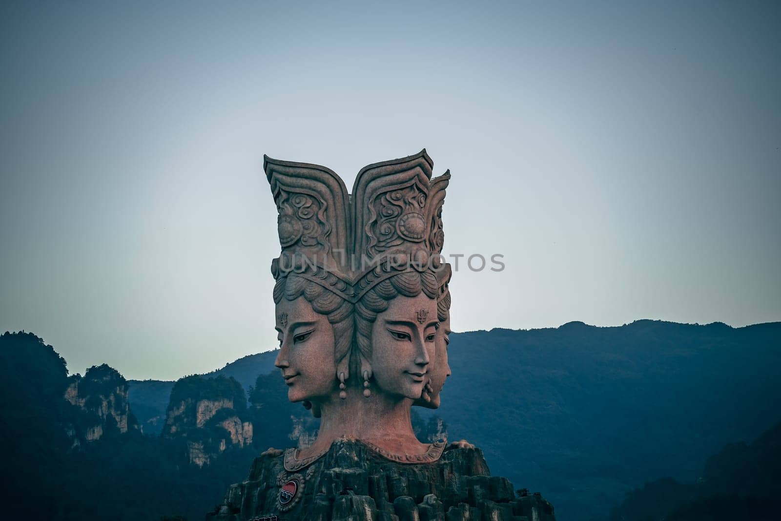 Wulingyuan, China -  August 2019 : Four faced sculpture at the entrance to the Romance Park located in Suoxiyu Town in Wulingyuan.  It is famous for the show of Zhangjiajie Romance performance.