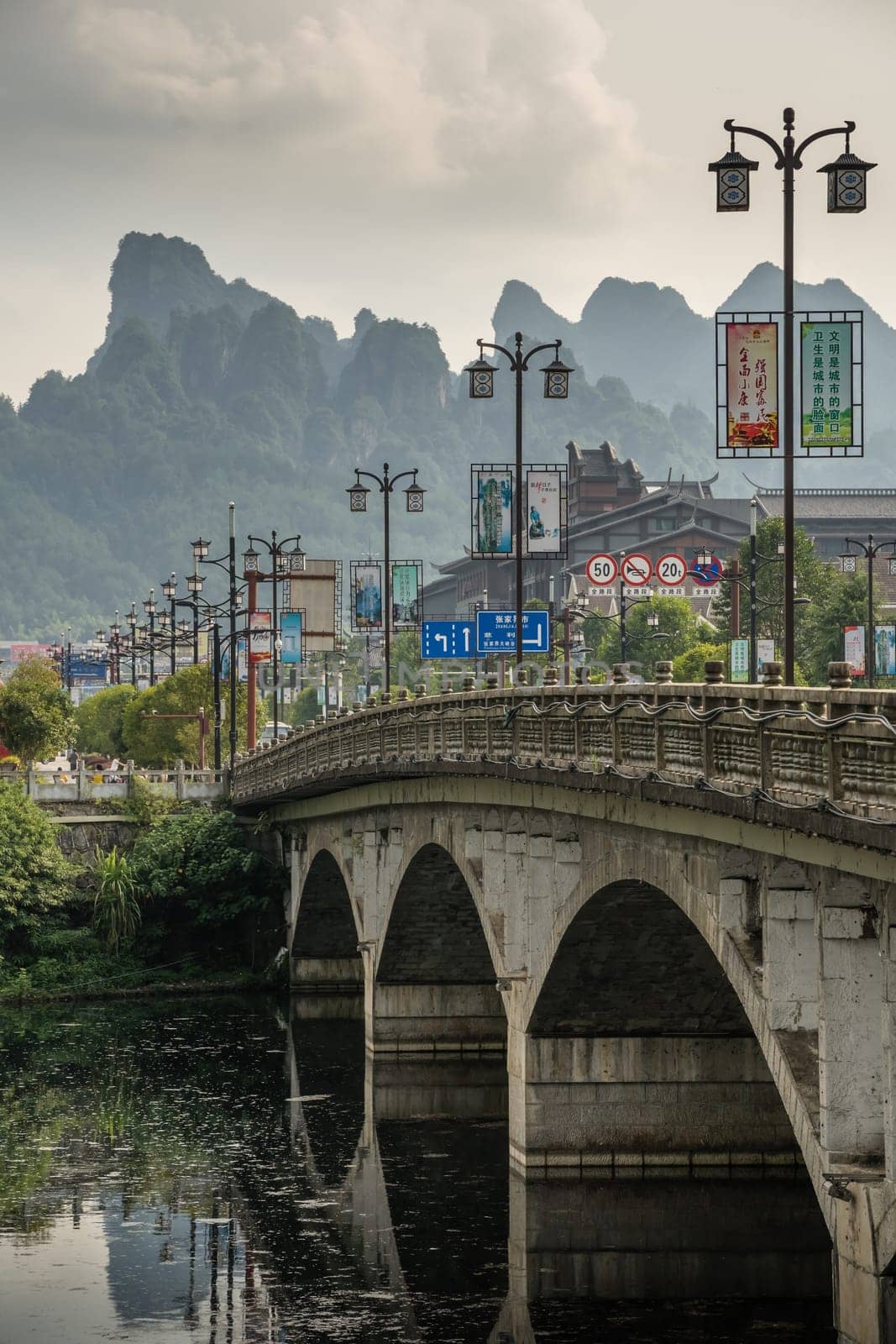 Wulingyuan, China - August 2019 : Wide arched bridge over Suoxiyu river in the ancient part of Wullingyuan town, Hunan Province