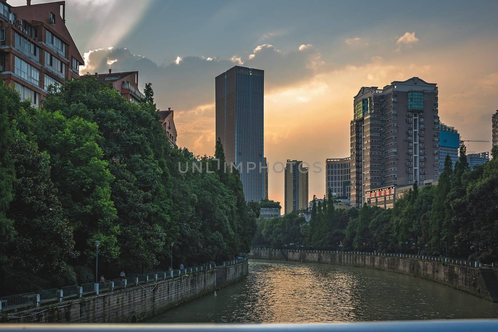 Chengdu, China -  July 2019 : Jin River flowing through Chengdu city at dusk, Sichuan Province