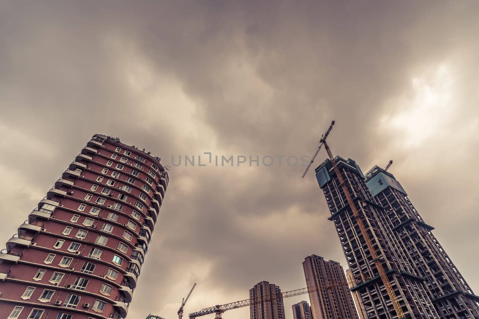 Chengdu, China -  July 2019 : Cranes on the building site of brand new high rise living apartments in the centre of town, Sichuan Province