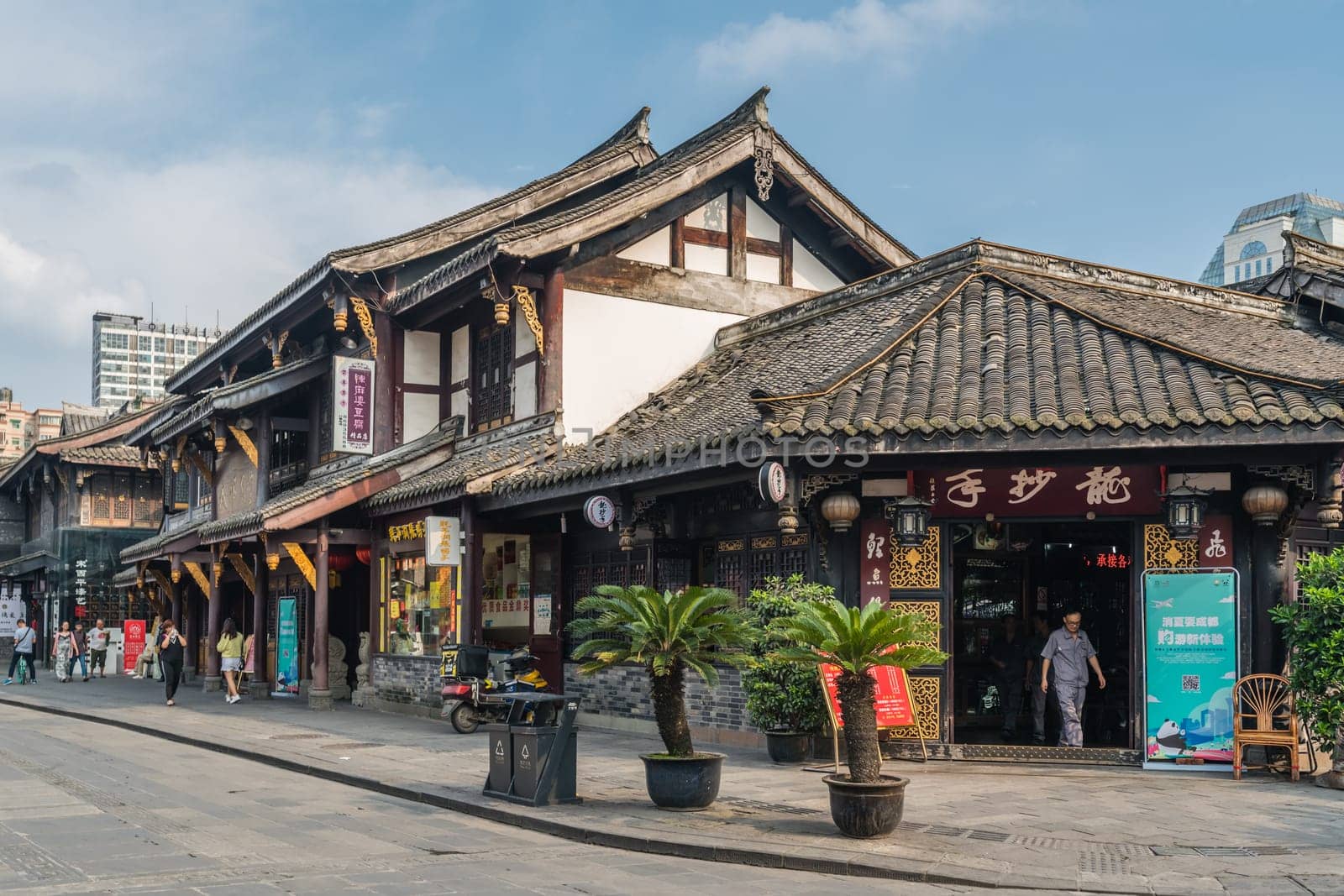 Chengdu, China -  July 2019 : Street scene in the city of Chengdu in summer, old traditional chinese buildings in the background, Sichuan Province