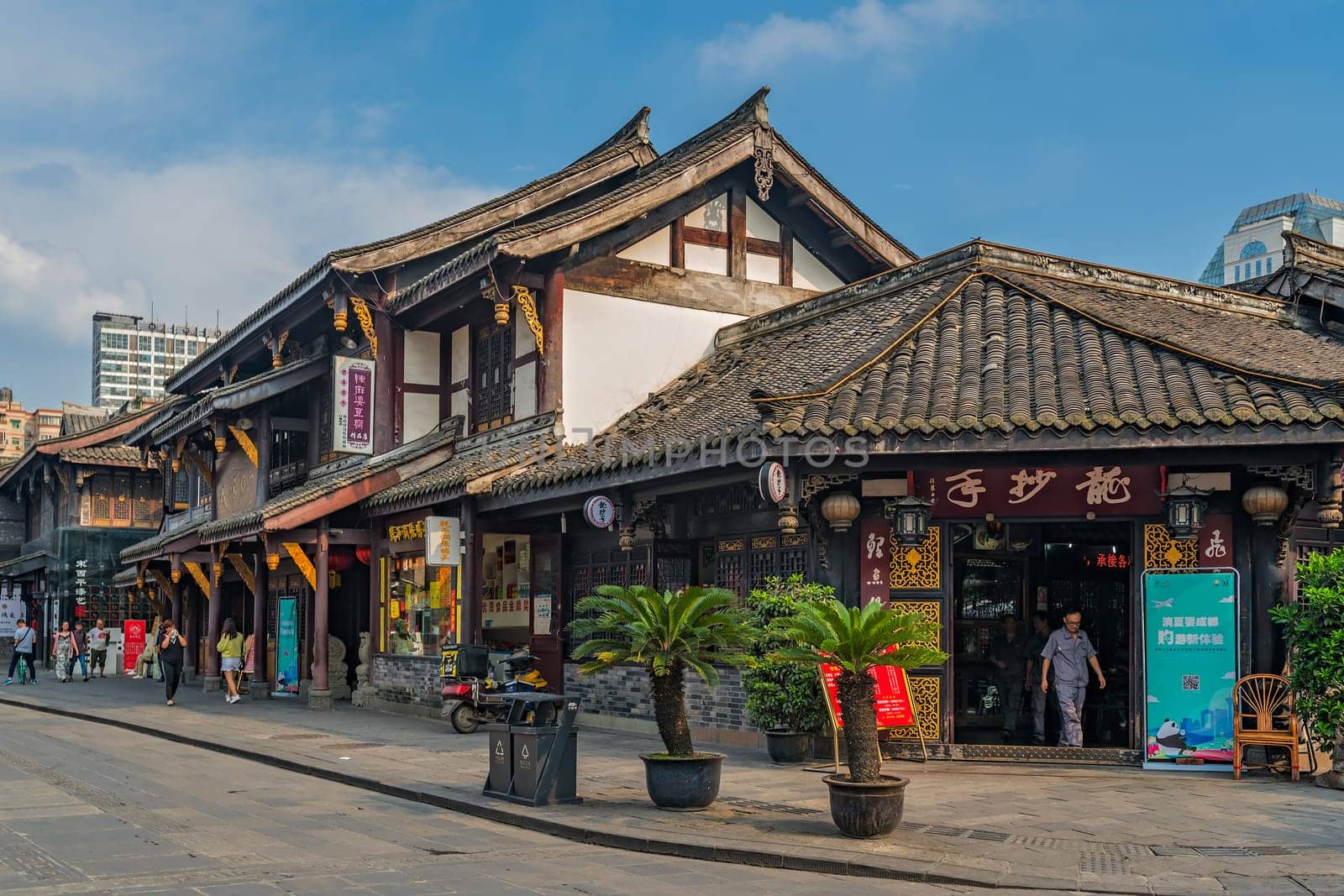 Chengdu, China -  July 2019 :  Street scene in the city of Chengdu in summer, old traditional chinese buildings in the background, Sichuan Province