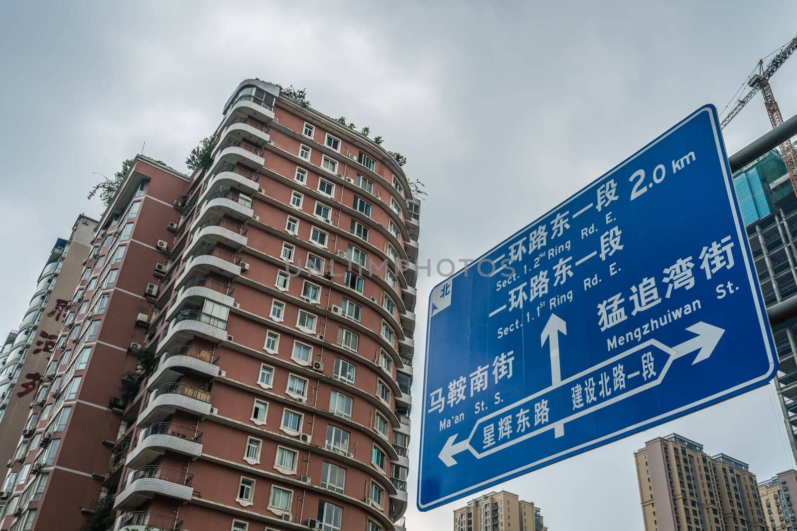 Chengdu, China -  July 2019 : Living apartments flats and road sign showing directions in the town centre, Sichuan Province