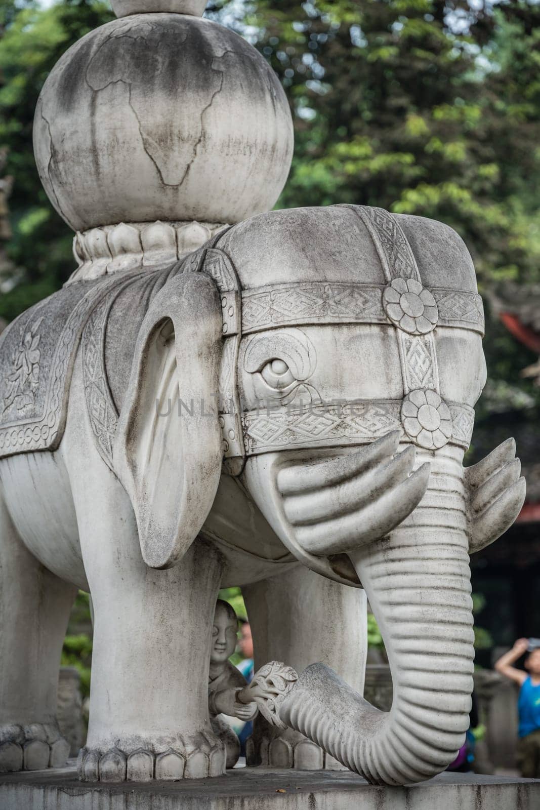 Chengdu, China -  July 2019 :  Large elephant sculpture figure in front of the landmark Thousand Buddha Pagoda in the courtyard of the Wenshu Monastery