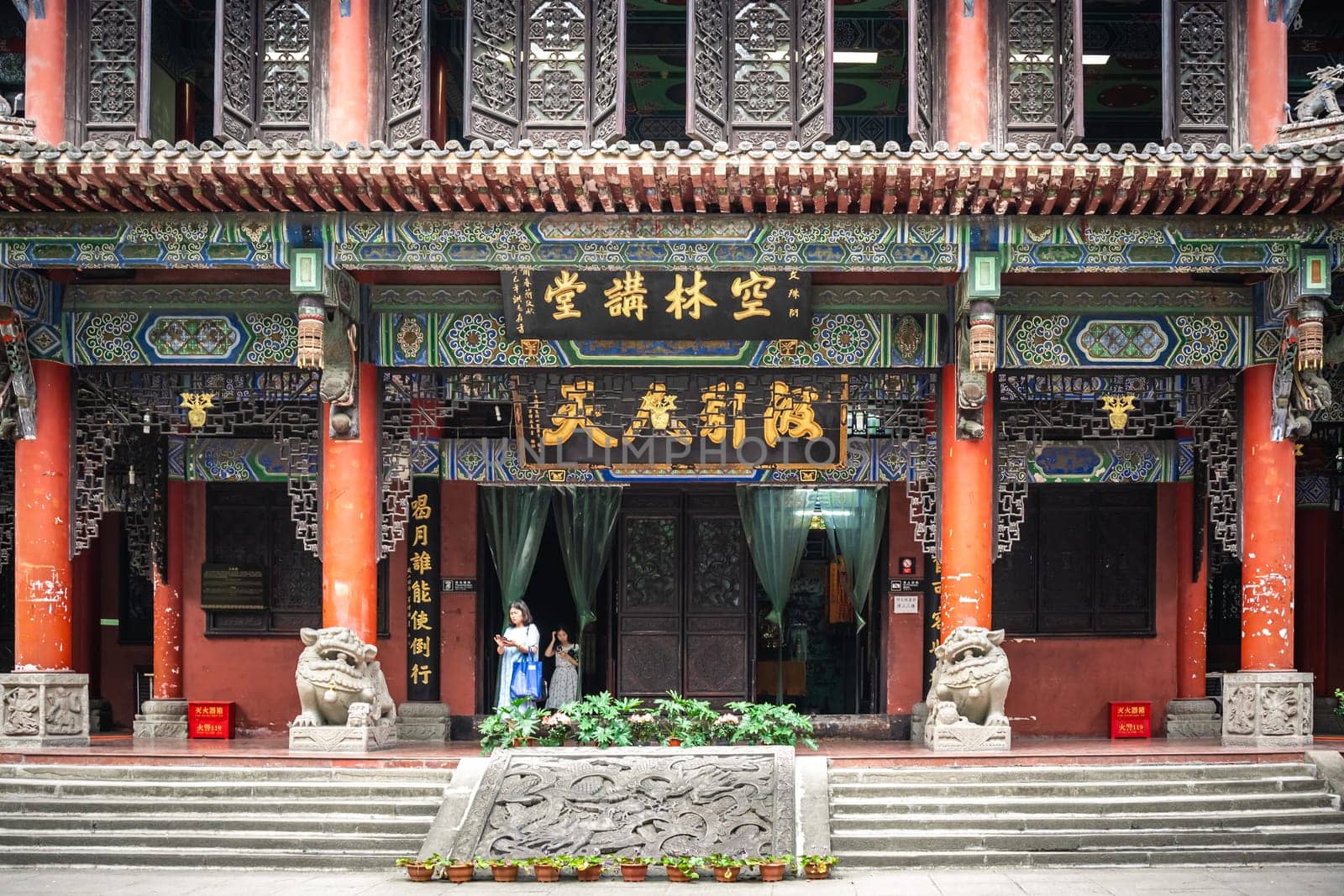 Chengdu, China -  July 2019 : People going through the door entrance of the impressive temple in Wenshu Monastery